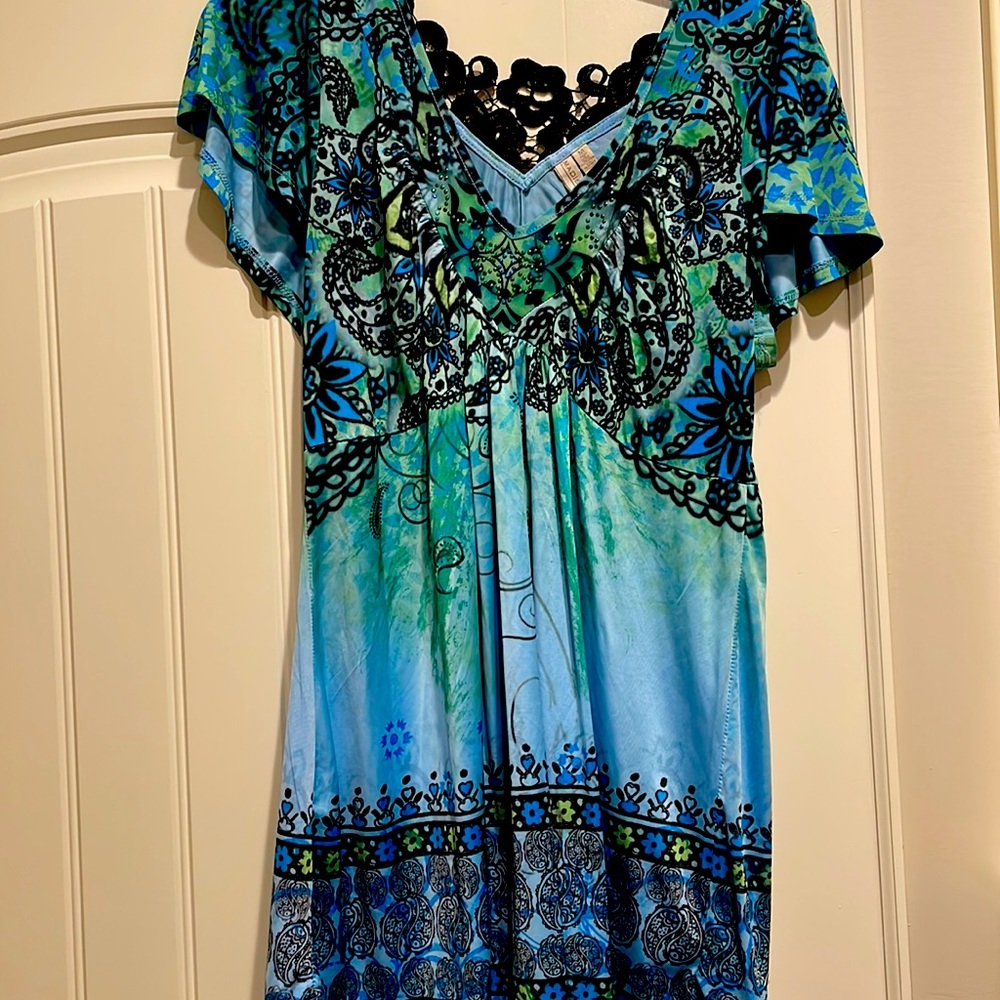 Exotic, fun, majestic hue of colors Vneck, with flutter sleeves.